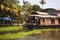 House-boat pleasure cruise ship in India  Kerala on the seaweed-covered river channels of Allapuzha in India. Boat on the lake in