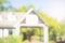 House building blurred background. trees and garden in front of home building, modern house in nature