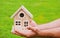 House in caring male hands. Hand holding toy house close up. Small miniature toy house. Mortgage property insurance