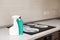 House cleaning - plastic bottles with detergents on kitchen tabletop on the background of electric stoves. Cleaning of induction s