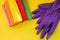House cleaning products on yellow table. cleaning supplies.Rubber protective gloves and colorful microfiber cleaning
