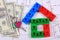 House of colorful building blocks, keys and banknotes on drawing