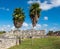 The House of Columns with two tall palm trees at ancient Mayan ruins of Tulum in Mexico