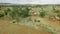 House construction building walls in African village among trees by a field