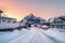 House covered snow with road surrounded with mountain at sunset