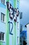 House detail of a modern apartment block, designed with a mural of a painted checkered butterfly and a pattern of polygonal shapes