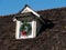 House detail with wooden roof and attic window