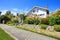 House with entance wooden archway and flower bed