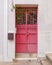 House entrance red painted metallic door, Athens downtown, Greece