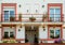 A house exterior with big balcony,colorful flowers