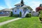 House exterior in light blue. View of front yard and entrance po