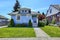 House exterior in light blue. View of front yard and entrance po