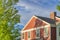 House exterior with rustic vinyl wood siding and chimney post with bricks at Daybreak, Utah