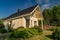 House exterior on a sunny day with a clear and blue sky.