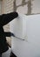 House exterior wall foam insulation. A close-up of a building contractor installing a rigid foam, styrofoam insulation on the