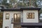 House facade with brown windows and wrought iron balcony