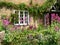 House facade with door and window, overgrown with creeper and flowers