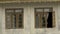 A house facade with glass windows in wooden frames