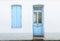 House facade with pastel blue blinds and door