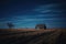 House in Field Under Night Sky, Serene Countryside Home With Clear View of Stars, A wide prairie under a clear, starry night sky,