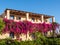 House framed by pink bougainvillea in Malia on crete island,