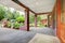 House front covered porch with wood door and spring landscape.