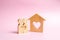 A house with a heart stands between a pair of lovers. The concept of finding a love nest. Mortgage, purchase credit.