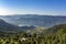 House on a hill, against the background of the city of Pokhara in a mountain foggy morning valley with Phewa lake under a clear