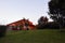 A house on a hill painted in the blossoming colors of the rays of the setting sun in Monteverde in Costa Rica