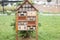 house for insects, insect hotel. Insect hotel in a green hedge gives protection and a nesting aid to bees and other insects