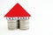 House insurance concept with small house from coins and wooden piece on white background