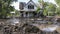 A house with its walls caved in and covered in a thick layer of mud a tragic image of the aftermath of the flood