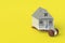 House and judge gavel on yellow background