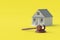 House and judge gavel on yellow background. Building legislation. Buying, selling housing