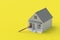 House and judge gavel on yellow background. Building legislation. Buying, selling housing. Lease contract