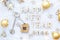 House key with keychain cottage on cozy festive knitted background with stars, bokeh. Happy New Year 2024 wooden letters, greeting