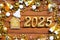 House key with tiny figure of home mock up on festive brown wooden background, lights of garlands. New Year 2025 wooden letters,