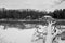 A house by lake covered by snow. Winter landscape. Lillian Anderson Arboretum in Kalamazoo Michigan. Black and white