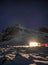 House lighting on snowy with starry over mountain