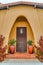 House in Long Beach California with arched entryway and brown wooden front door