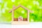 House model with percentage symbol and green nature background, Housing interest rates, mortgage, loans and refinance concept
