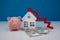 House model, piggy bank and arrow up. The concept of inflation, economic growth, the price of insurance services
