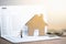 House model and small couple figures in love standing on bank passbook.