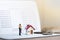 House model and small couple figures in love standing on bank passbook.