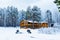 House in a nature area covered with freshly fallen snow.