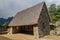 House near ceremonial rock at Machu Picchu ruins, Pe