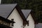 House with new brown metal tile roof and rain gutter. Metallic Guttering System, Guttering and Drainage Pipe Exterior