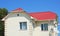 House with new metal roof, rain gutter, stucco, plastering and painting walls