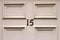 House number 15 on a white square panelled wooden front door in Britain