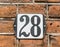House Number 28 on traditional Dutch brick wall